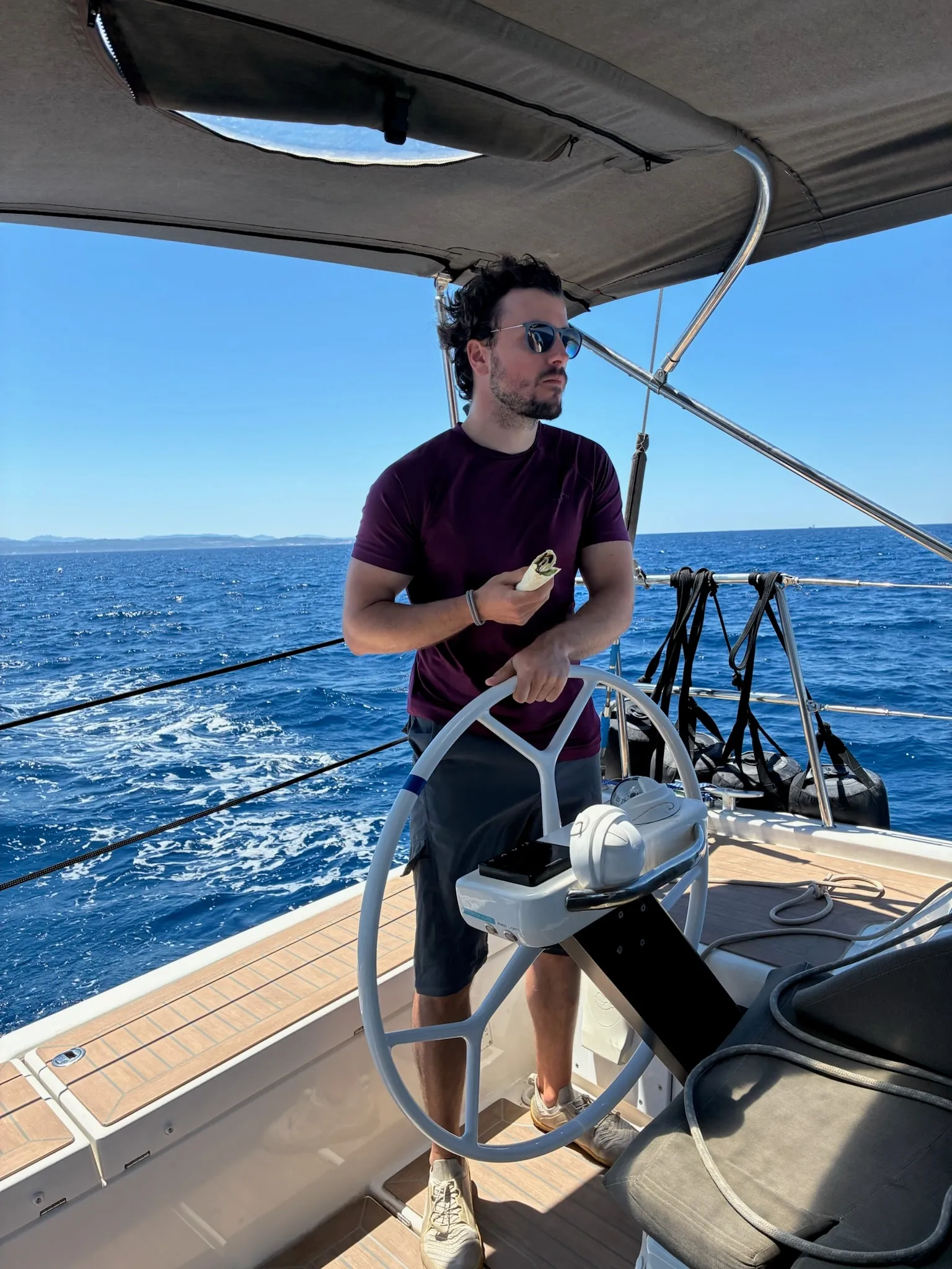 Jarno at the helm of a sailing yacht off the coast of Sardinia